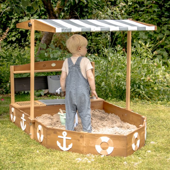 Bac à sable AXI Dora Boot avec cuisine ludique et toit (UV50) 160 x 100 cm Anthracite/marron – Avec tableau noir et espace de rangement - Toile de protection incluse - Garantie 10 ans !